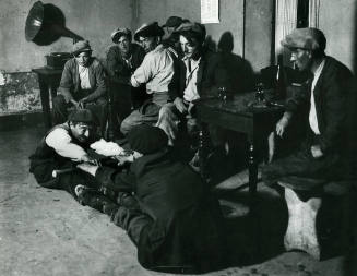 Men in bar, two on the floor stretching, Savoie